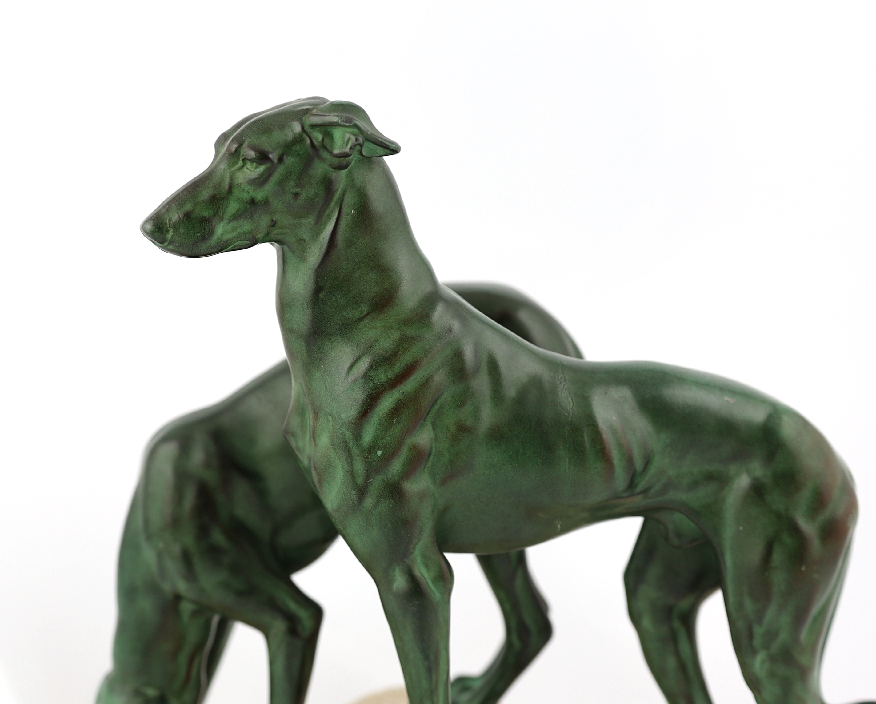 Masson, a French Art Deco bronze and composition stone group of two hounds watering, 32cm long, 12cm deep, 28cm high